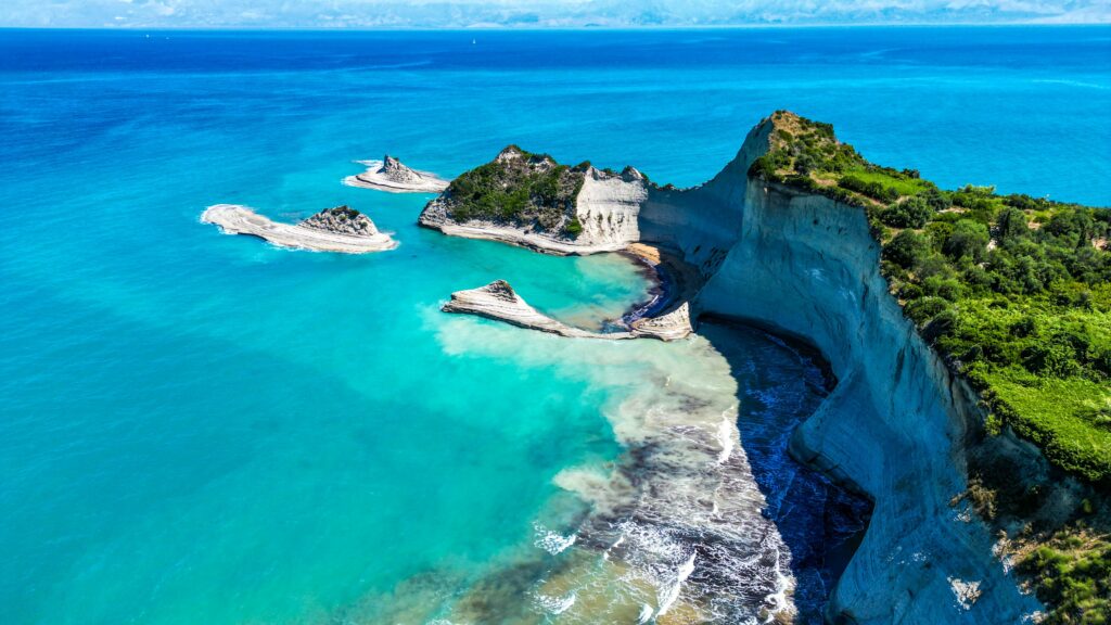 Aerial of Cape Drastis on Corfu Island surrounded by the turquoise water of Ionian sea in Greece