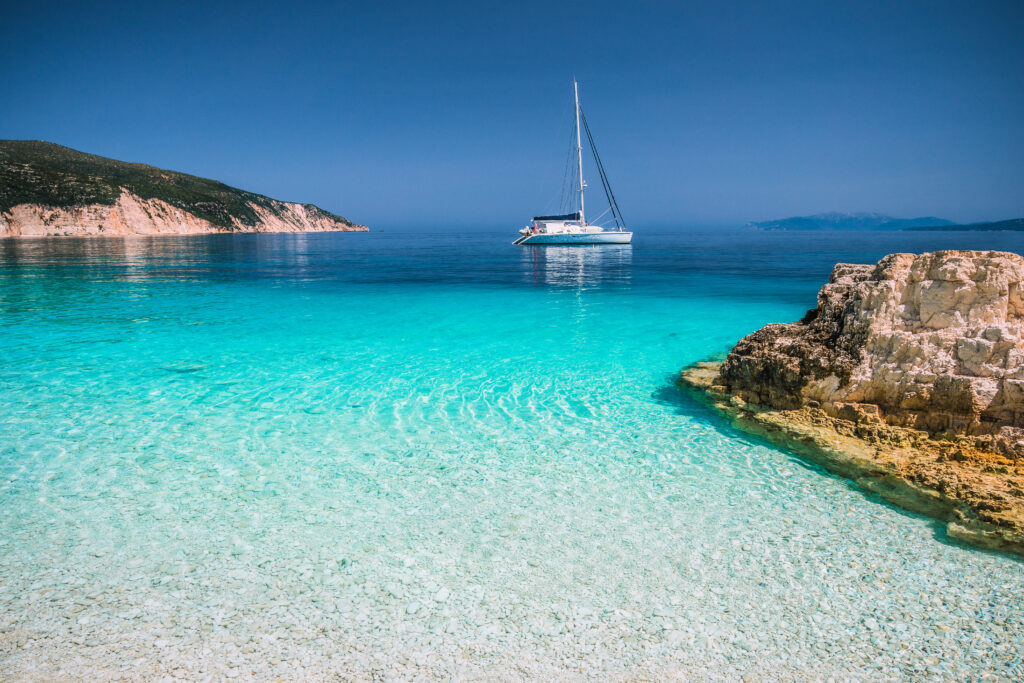 beautiful-azure-blue-lagoon-with-sailing-catamaran