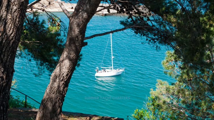 Secluded yacht charter destination with a sailboat on calm waters