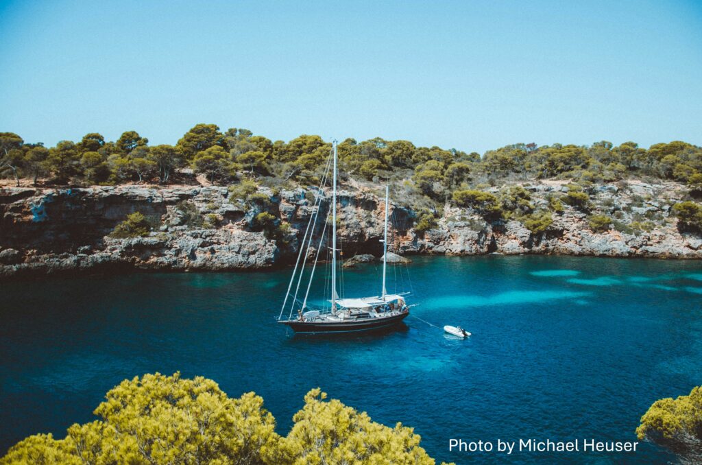 serene yacht anchored near a crystal-clear coastline