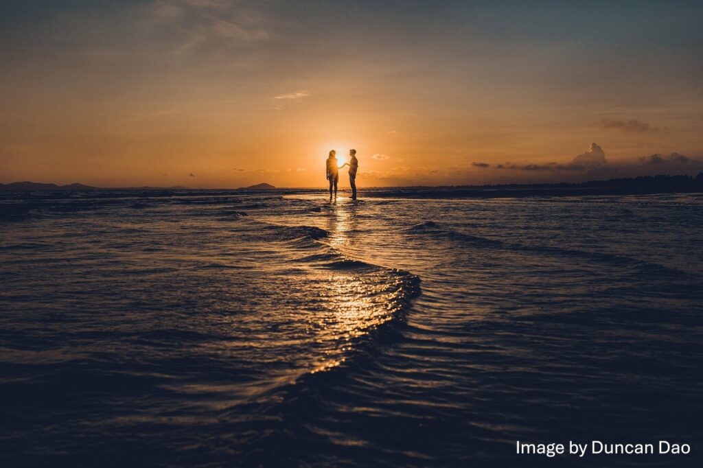Romantic couple on the beach in the sunset