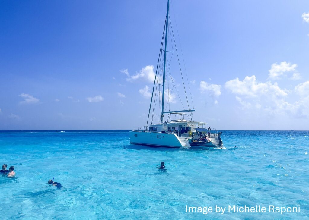 Catamaran on turquoise water and family yacht charter